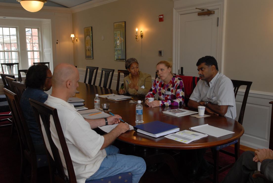 Houston Team meeting at the Intensive Session, July 2006. (Clockwise from bottom left: National Fellows Daniel J. Addis, Jurline Tarver Franklin, Michea R. Carter, and Karlene E. McGowen; and Gemunu Heart Gunaratne, Professor of Physics, University of Houston.)